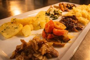a white plate of food on a table at Affittacamere Al Fiume in Flambruzzo