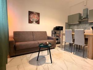 a living room with a couch and a table at Il Piano B in Molinella +10 photos