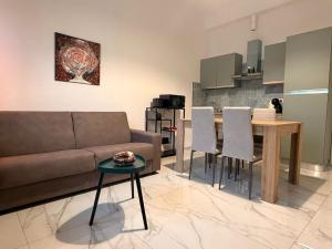 a living room with a couch and a table at Il Piano B in Molinella