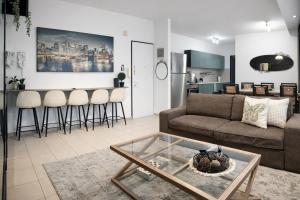 a living room with a couch and a table at Stylish Tel Aviv in Tel Aviv