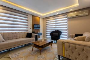 a living room with a couch and a table at Avullar Palace Hotel in Antalya