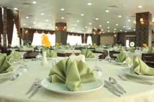 a dining room with a table with plates and silverware at Hotel RABİS in Urfa