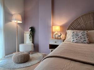 a bedroom with a bed and a lamp and a chair at Chianti's Secret Nest - Cozy home with sunset view in Impruneta