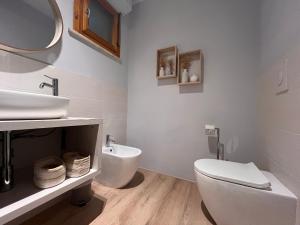 a bathroom with a white toilet and a sink at Chianti's Secret Nest - Cozy home with sunset view in Impruneta +40 photos