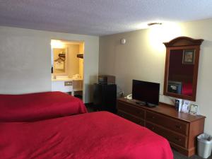 a hotel room with two beds and a television at FairBridge Inn Express Merrillville in Merrillville