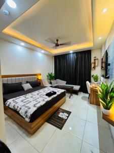 a bedroom with a bed and a living room at Moon Path Stay in Nalmatha