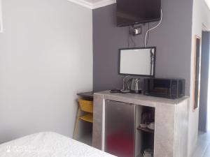 a room with a microwave and a tv on a table at Galaxy Bed and Breakfast in Butha-Buthe