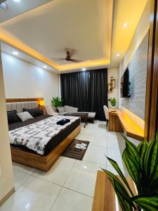 a bedroom with a bed and a living room at Moon Path Stay in Nalmatha
