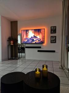 a living room with a tv on a wall at Viktoria Apartment in Speicher