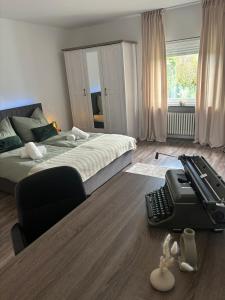 a bedroom with a bed with a desk and a computer keyboard at Viktoria Apartment in Speicher