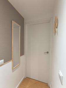 an empty room with a door and a mirror at Casa do Bento - Charming Cozy Loft, Vila do Conde in Fajozes +10 photos