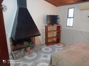 a living room with a fireplace and a tv at Casanuestra in San Javier