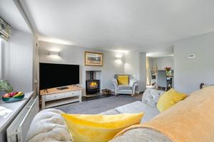a living room with a couch and a flat screen tv at 2 Bed in Bush oc-s31846 in Bude