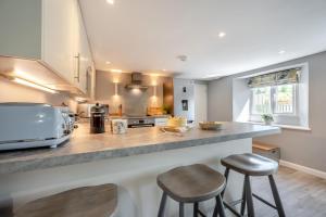 a kitchen with two stools and a counter top at 2 Bed in Bush oc-s31846 in Bude +24 photos