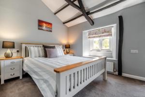 a bedroom with a white bed and a window at 2 Bed in Bush oc-s31846 in Bude