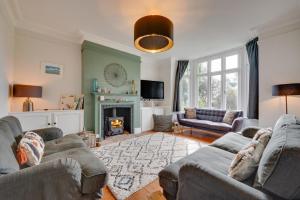 a living room with two couches and a fireplace at 5 Bed in Walberswick oc-tww in Walberswick