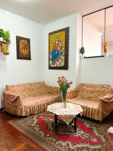a living room with two couches and a table at Hostal Violeta in Arequipa