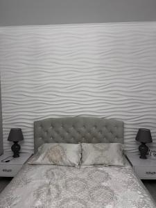 a bedroom with a bed with two lamps on tables at Апартаменты Аркадия Гагарин Плаза У моря Без комиссии in Odesa