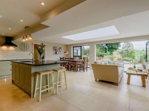 a kitchen and living room with a couch and a table at 4 Bed in Oswestry oc-87477 in Llansilin