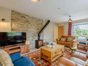 a living room with a tv and a fireplace at 4 Bed in Oswestry oc-87477 in Llansilin