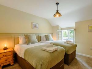 a bedroom with two beds and a window at 4 Bed in Oswestry oc-87477 in Llansilin