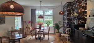 a kitchen and dining room with a table and chairs at B&B Grolloo in Grolloo