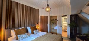 a bedroom with a bed with pillows on it at B&B Grolloo in Grolloo