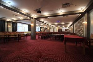 a large room with tables and chairs in it at Алма Ата in Borovoye