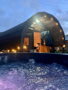 a dog is sitting next to a pool of water at Glamping Life Retreat in Nantmel