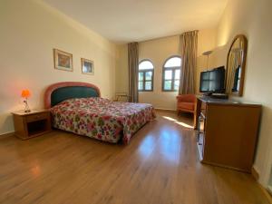 a bedroom with a bed and a flat screen tv at Rabieh Guest house in Rabieh