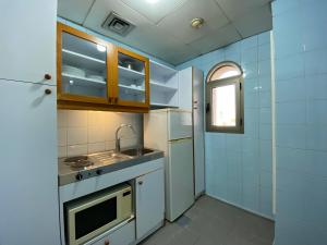 a small kitchen with a sink and a refrigerator at Rabieh Guest house in Rabieh