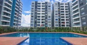a swimming pool in front of some tall buildings at Comfy Bnb in Syokimau