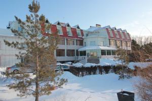 a large building with snow in front of it at Алма Ата in Borovoye