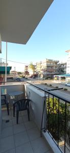a balcony with a table and chairs on a building at Sunrise1 in Paralia Katerinis
