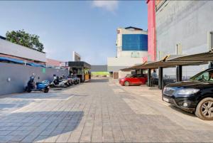 a parking lot with cars parked next to a building at Soorya in Attingal