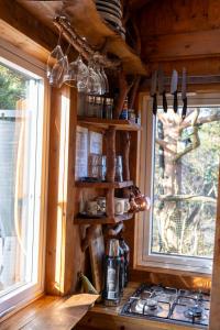 a kitchen with a stove and a window at Gluba Treetop Cabins Furunåla in Harkmark +15 photos