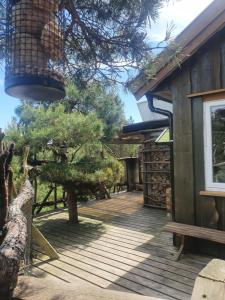 a porch of a house with a wooden deck at Gluba Treetop Cabins Furunåla in Harkmark