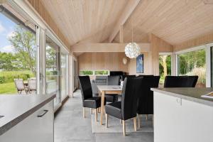 a kitchen and dining room with a table and chairs at 20422-Samso-Egernvej-16 in Ballen +57 photos