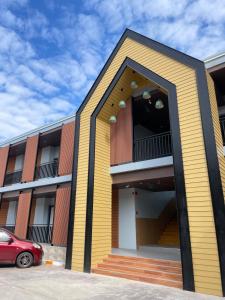 a red car parked in front of a building at SiLin Hotel in Ban Nong Pling