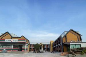 a group of buildings in a parking lot at SiLin Hotel in Ban Nong Pling +4 photos