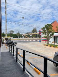 a group of motorcycles parked in a parking lot at SiLin Hotel in Ban Nong Pling