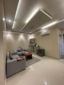 a living room with a couch and a table at Elsafa Hotel in Salalah +34 photos