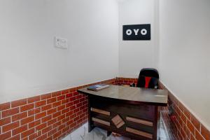an office with a desk and a sign on the wall at SPOT ON Hotel MS Grand in Lucknow