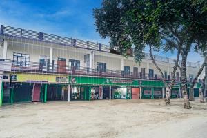 a building with colorful doors and windows and a tree at SPOT ON Hotel MS Grand in Lucknow +21 photos