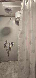 a shower in a bathroom with a shower curtain at Nala Host-Luxor studios in Male City +49 photos