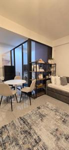 a living room with a bed and a table and chairs at Nala Host-Luxor studios in Male City