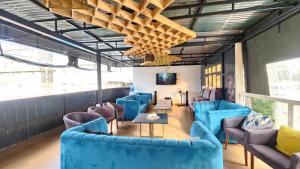 a room with blue chairs and a table at Kamakis Motel & Lounge in Ruiru +14 photos