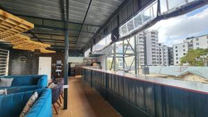 a balcony with blue furniture and a view of a city at Kamakis Motel & Lounge in Ruiru