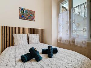 a bedroom with a bed with two stuffed animals on it at Le Pianiste in Voiron
