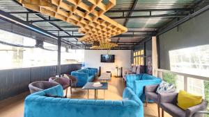 a waiting room with blue chairs and a table at Kamakis Motel & Lounge in Ruiru